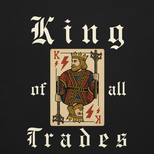 Close up Black shirt with bold king of trades text. Lineman holding power poles and lightning bolts on playing card.