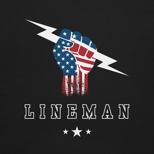 close up of shirt with USA flag fist holding lightning bolt and bold LINEMAN text and stars underneath