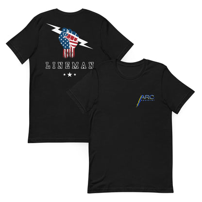 Black shirt with USA flag fist holding lightning bolt and bold lineman text on back and stars underneath. On front Arc Apparel logo